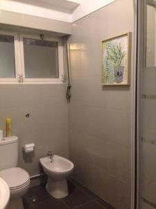 a bathroom with a toilet and a sink at Palm Guesthouse B&B Rooms in Cascais