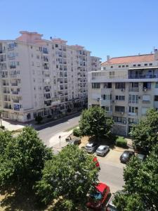 an apartment complex with cars parked in a parking lot at Apartments Natali in Bar +20 photos