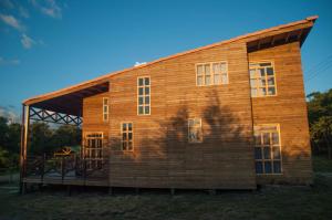 a large wooden house with a gambrel roof at Cabañas ecológicas Xuetama in Villa de Leyva