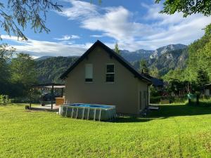 a small house with a swimming pool in a yard at Haus Rading in Rading