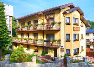 a building with flower boxes on the balconies at Willa Sonata in Karpacz
