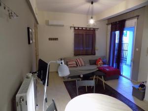 a living room with a couch and a table at George's Apartment in Volos area in Volos