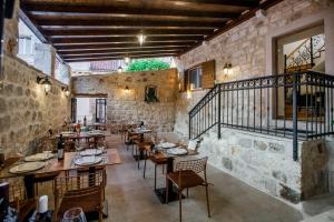 a restaurant with tables, chairs, and tables in it at Heritage Hotel Dea Hvar in Hvar