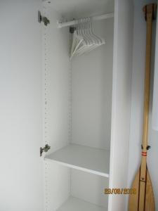 a closet with white walls and white shelves at Hausboot Paulada-Mare in Flensburg