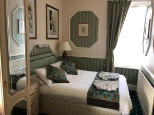 Ένα ή περισσότερα κρεβάτια σε δωμάτιο στο Everglades Hotel