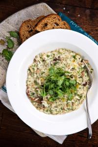 a bowl of risotto with bread and a plate of food at Victoria in Holkham