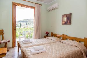 Ένα ή περισσότερα κρεβάτια σε δωμάτιο στο Ancient Assini Apartments