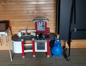 a lego kitchen with a table with a mixer and a toy pig at Domek na Cichej Leśniewo in Leśniewo