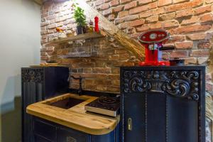 a kitchen with a stove and a brick wall at Nomad in Cluj-Napoca +34 photos