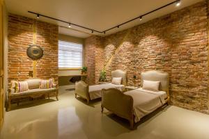 a room with two beds and a brick wall at Nomad in Cluj-Napoca