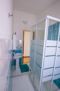 a bathroom with a glass shower and a sink at Sun & Sea, holidays home in Fontane Bianche