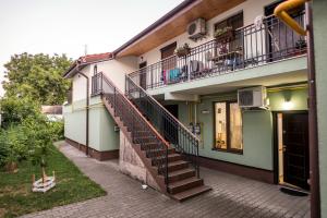 an apartment building with stairs and a balcony at D&O Zola in Timişoara