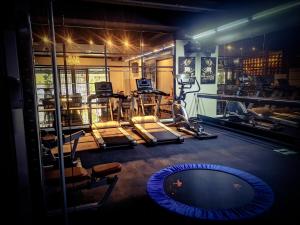 a room with a gym with weights and a simulator at 1969 Business Suites Bandar Botani, Ipoh in Ipoh +43 photos