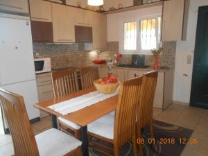 a kitchen with a table with a bowl of fruit on it at Myrto's House in Vouniatádes