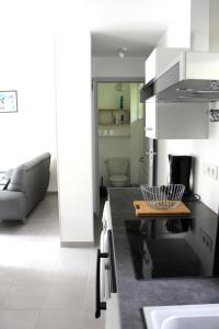 a kitchen with a table and a couch in a room at Maison gîte à Vire Normandie (Les Vaux de Vire) in Vire