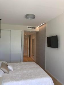 a bedroom with a bed and a flat screen tv at Bel Etage Luxury Rooms in Split