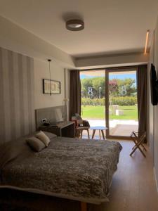 a bedroom with a bed and a view of a yard at Bel Etage Luxury Rooms in Split