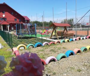 a park with a playground with a colorful play area at Pensiunea TAVISA in Sighetu Marmaţiei