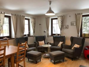 a living room with a couch and chairs and a table at Apartmány Sportrelax in Albrechtice v Jizerských horách