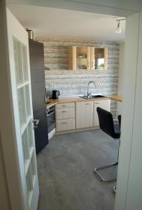 a small kitchen with a sink and a stove at Ferienwohnung Wiekenblick in Wiesmoor