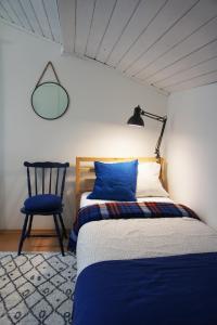 a bedroom with a bed and a chair and a lamp at RowerowyFun in Nowy Sącz