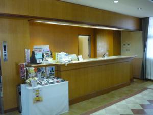 a waiting room with a counter and a counter sidx sidx sidx at Takada Terminal Hotel in Joetsu