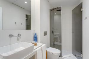 a white bathroom with a sink and a toilet at Oporto Home Wine Cellars in Vila Nova de Gaia
