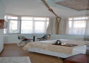 une chambre avec un lit, une table et des fenêtres dans l'établissement Yeni Hotel, à Istanbul