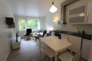 a kitchen and living room with a table and chairs at Trolltunga Camping in Odda +49 photos
