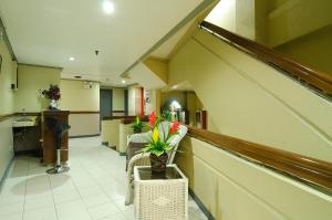 a lobby of a hospital with a table with a plant at Asia Stars Hotel in Tacloban