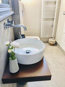 a bathroom with a white sink on a wooden table at Sciri Suite #1 in Perugia +53 photos