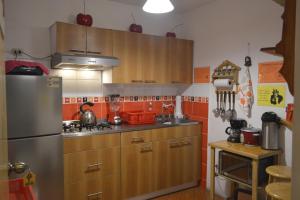 a kitchen with wooden cabinets and a stainless steel refrigerator at Amelita Hotel Boutique in Huaraz +26 photos