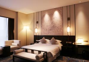 Кровать или кровати в номере Amitabha Hotel (Fuzhou Pushang)