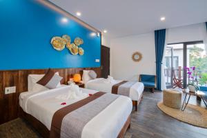 Postel nebo postele na pokoji v ubytování December Hoi An Villa