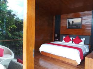 
A bed or beds in a room at Manohara Resort
