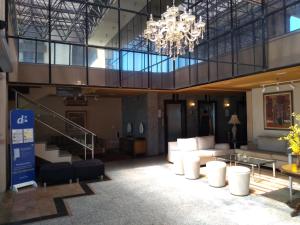 a large lobby with a chandelier in a building at Apto Beira Mar 2102 in Fortaleza +51 photos