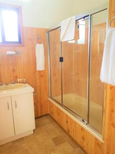 a bathroom with a shower and a sink at Broken River Mountain Resort in Eungella