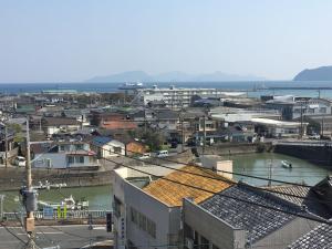 a view of a city with a river and buildings at コンドミニアムホテル Stay inn Blue in Hukue