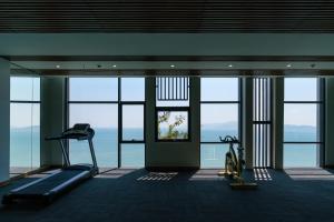 a gym with a view of the ocean at Joy Trip Hotel & Spa Nha Trang in Nha Trang