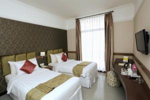 Postel nebo postele na pokoji v ubytování Amarelo Hotel Solo