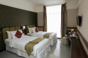 Postel nebo postele na pokoji v ubytování Amarelo Hotel Solo
