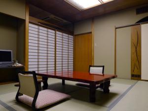 a dining room with a table and two chairs at Kinokuniya Ryokan in Hakone
