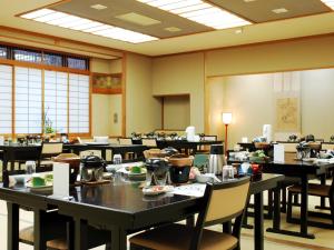 a large dining room with tables and chairs at Kinokuniya Ryokan in Hakone