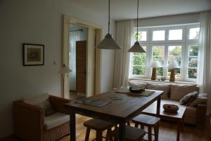 a living room with a table and a couch at Altes Landhaus am Park in Xanten