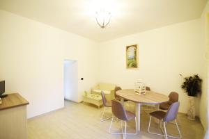 a dining room with a table and chairs at Il Trullo Bianco in Selva di Fasano +42 photos