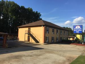 a large building with a staircase in front of it at Americas Best Value Inn Stone Mountain Atlanta E in Stone Mountain