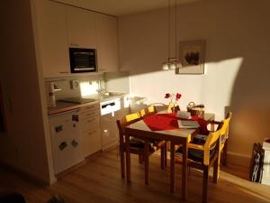 a kitchen and dining room with a table and chairs at Apartment Abendrot in Sankt Englmar