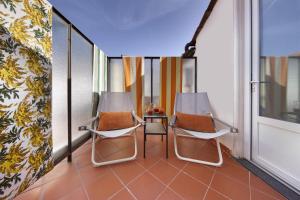 two chairs and a table on a balcony at Amore Rentals - Casa La Maisonette in Sorrento
