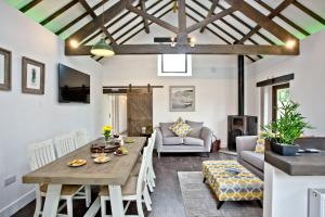 a living room with a wooden table and a couch at The Barn in Lanhydrock, Bodmin in Bodmin