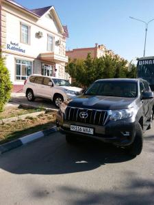 a black suv parked in a parking lot at RATMINA HOTEL in Nukus